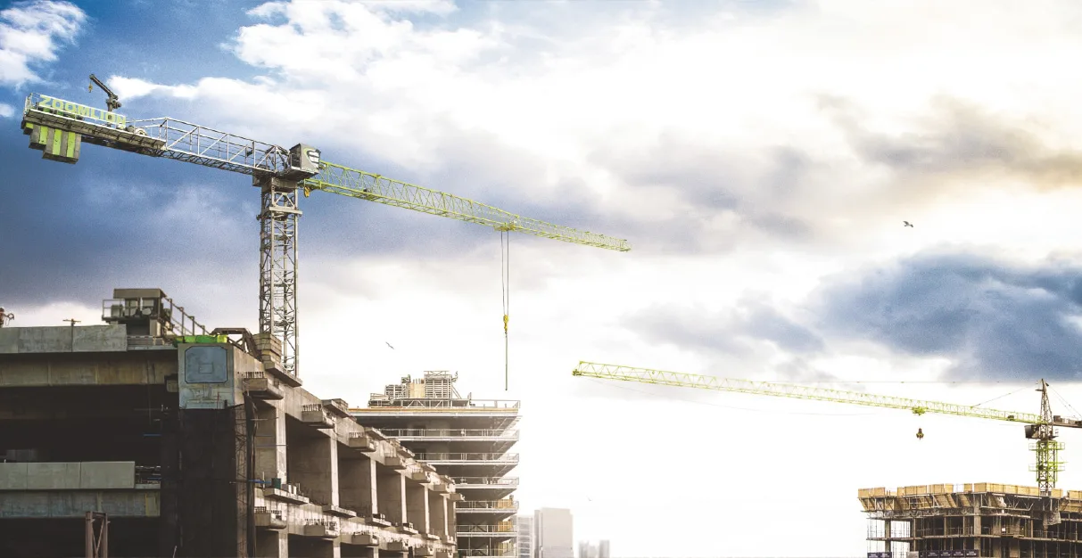 Tower cranes working over a building under construction